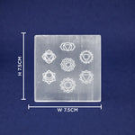 Transparent square crystal with chakra symbols and measurements on a blue background