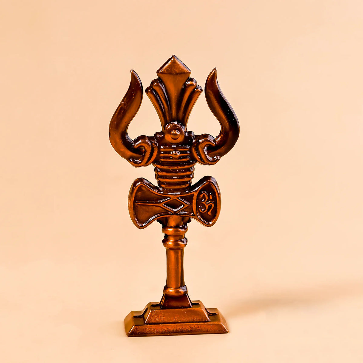 Wooden trident on a beige background