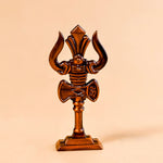 Wooden trident on a beige background