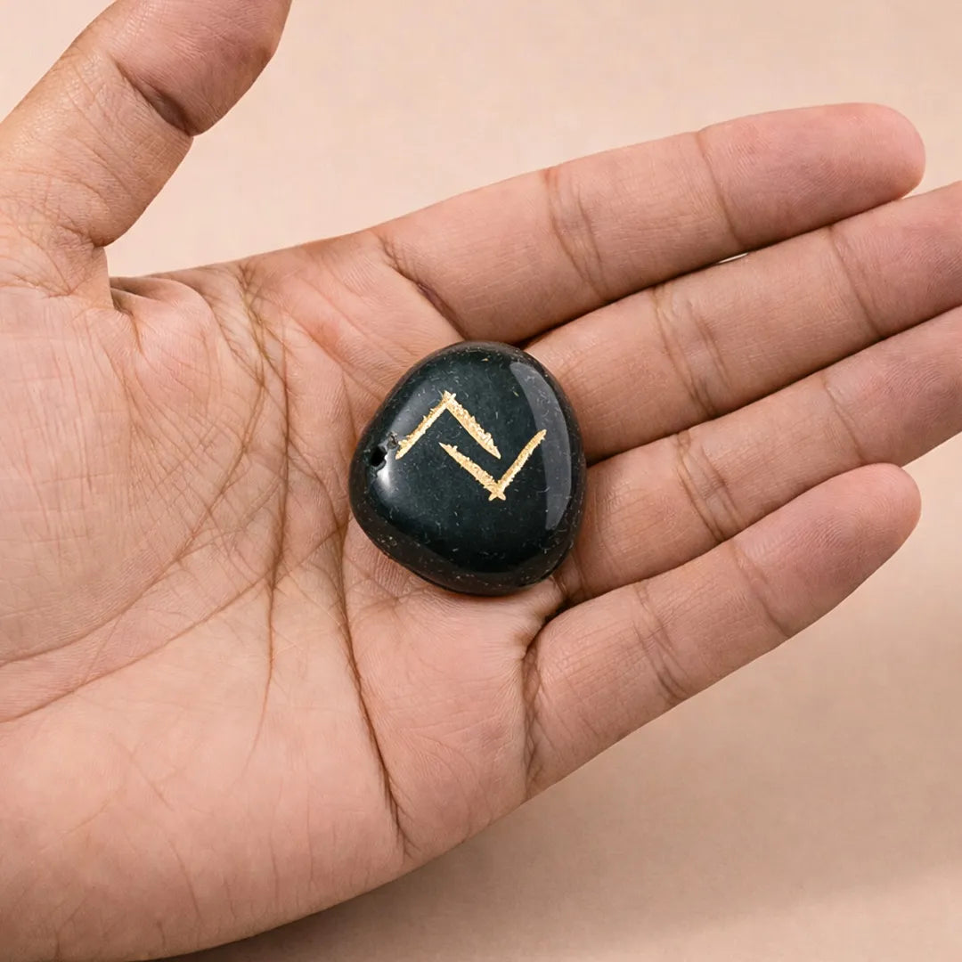 Black stone with gold symbol held in a hand against a beige backgroundप्राकृतिक हरा एगेट (रेकी प्रतीक) 5 का पैक - अभिमंत्रित और प्रमाणित