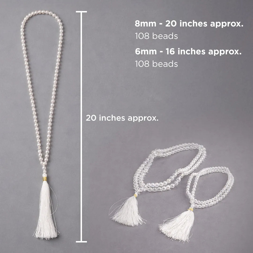 White beaded necklace with tassels on a gray background, showing measurements.