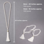 White beaded necklace with tassels on a gray background, showing measurements.