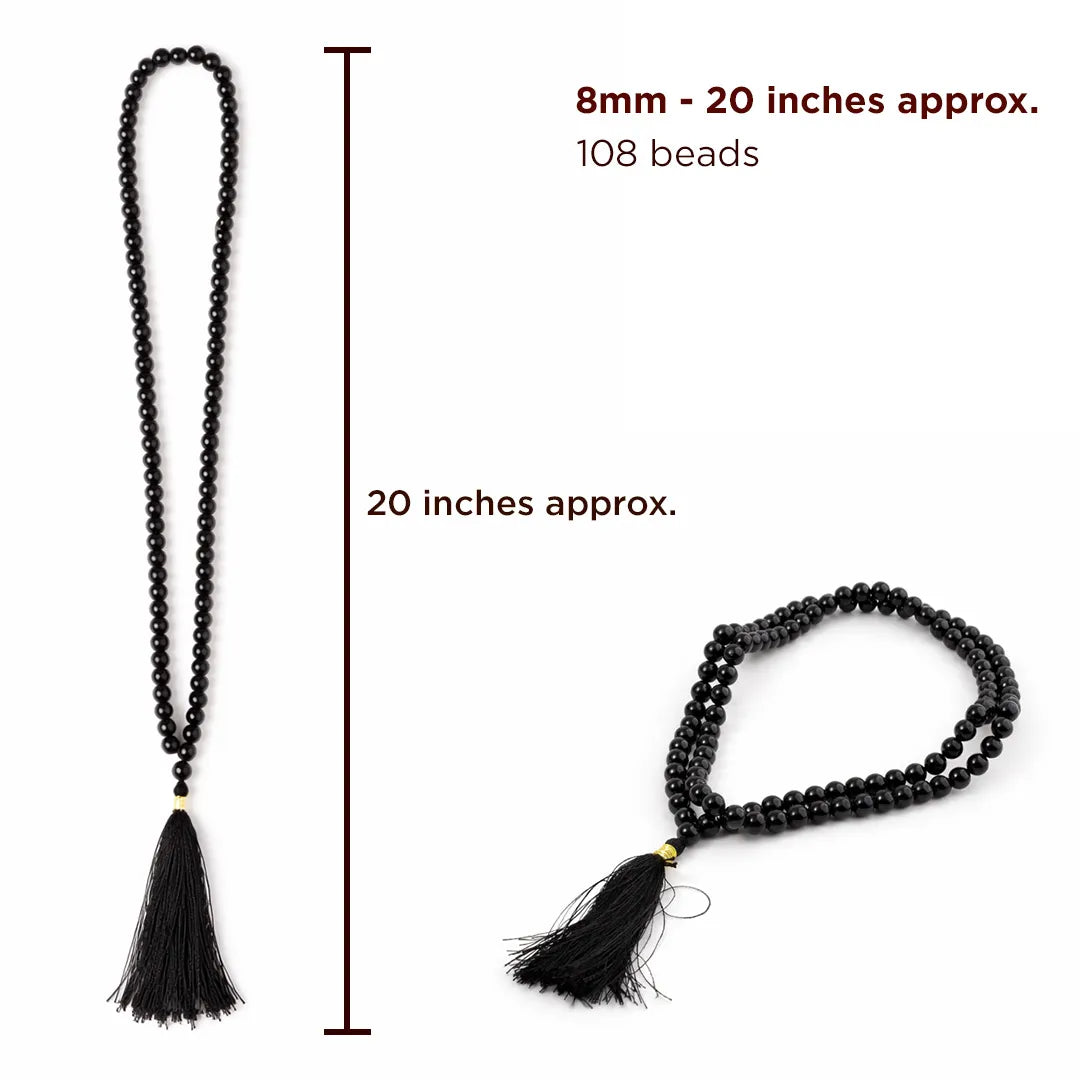 Black beaded necklace with tassels and measurements on a white background