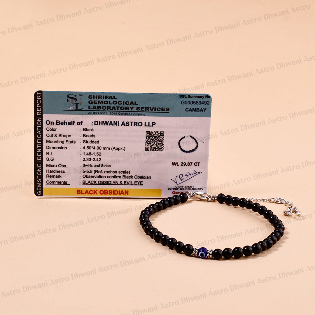 A black obsidian beaded bracelet with a silver chain and a blue evil eye charm, displayed in front of its official Shirkal Geological Laboratory Services certificate card on a beige background.Black Obsidian Anklet | Evil Eye Protection Anklet | Positivity & Negative Energy Shield