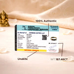 Certification label for unakite stone with weight and authenticity details on a soft fabric background.