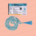 A necklace of light blue round beads with a matching blue tassel, displayed on a peach background alongside a gemological certificate