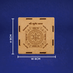 Brown square object with engravings and measurements on a blue background