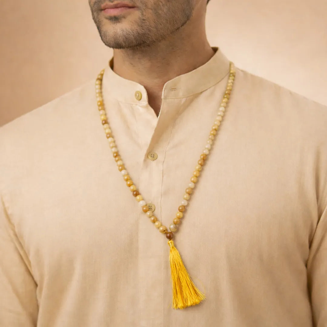 Man wearing a beige kurta with a long beaded necklace featuring a yellow tassel.Yellow Aventurine Crystal Mala – Prosperity, Confidence & Success Energy Mala
