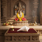 Altar with a statue, flowers, and offerings in a temple setting