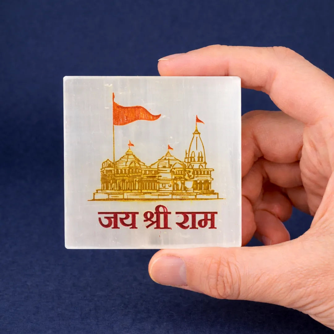 Hand holding a card with a temple illustration and text against a blue background