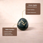 Green agate stone with Reiki symbol on a beige background