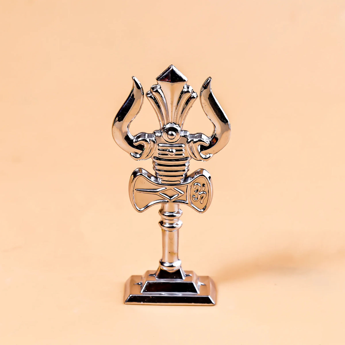 Metallic microphone-shaped trophy on a beige background