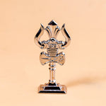 Metallic microphone-shaped trophy on a beige background