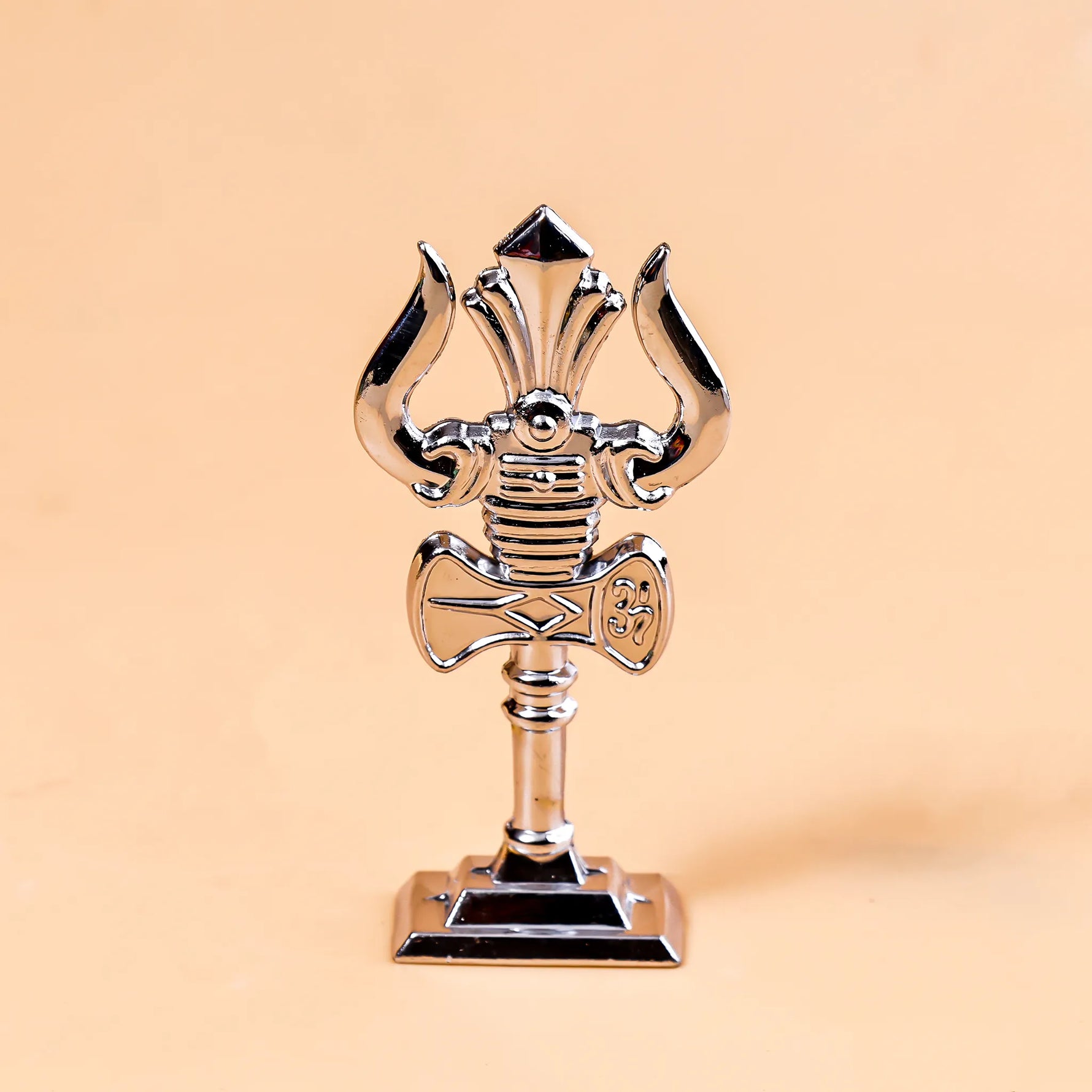 Metallic microphone-shaped trophy on a beige backgroundMurugan Trishul Vel – Abhimantrit & Certified