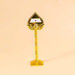 Decorative item with a gold base and a triangular top on a beige background