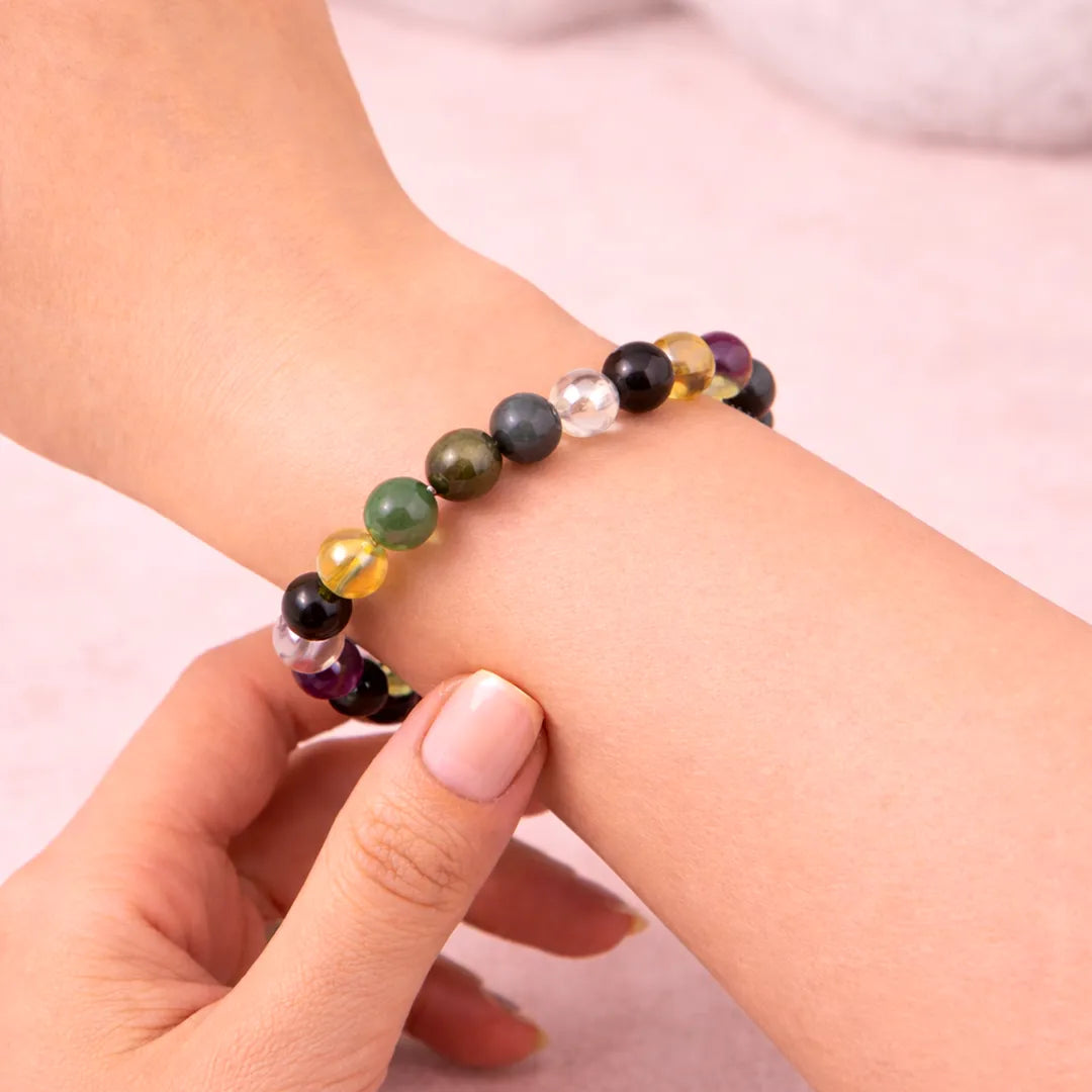 Multicolored beaded bracelet on a wrist against a light backgroundLibra Zodiac Bracelet – Natural Multi Stone Bracelet for Balance – Abhimantrit