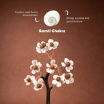 Gomti Chakra with decorative flowers on a brown background