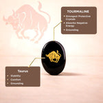 Black tourmaline crystal with Taurus symbol and information on a pink background