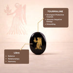 Black tourmaline crystal with angelic design on a pink background, featuring Libra zodiac sign associations.