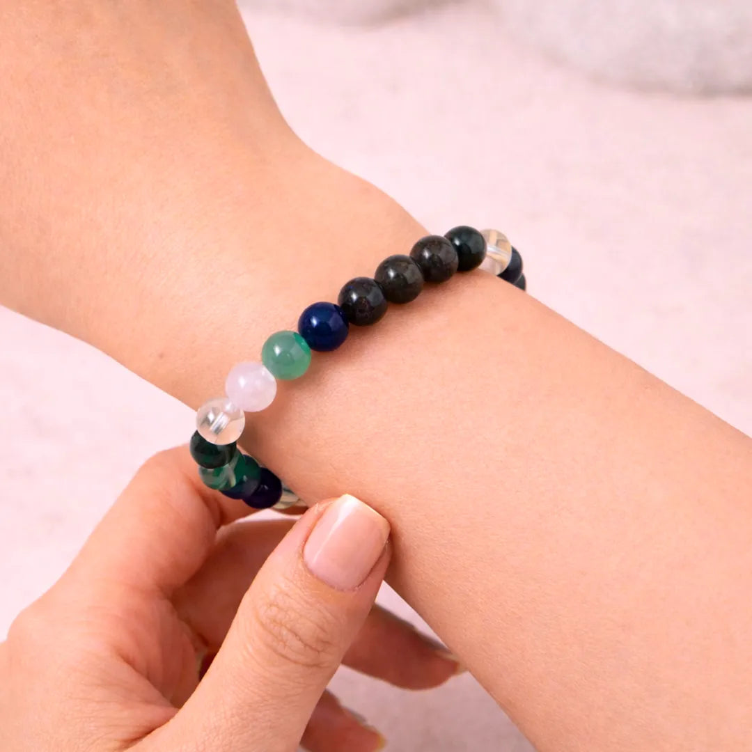 Bracelet with multicolored beads on a wrist against a light backgroundTaurus Zodiac Bracelet – Natural Multi Stone Bracelet – Abhimantrit & Energized