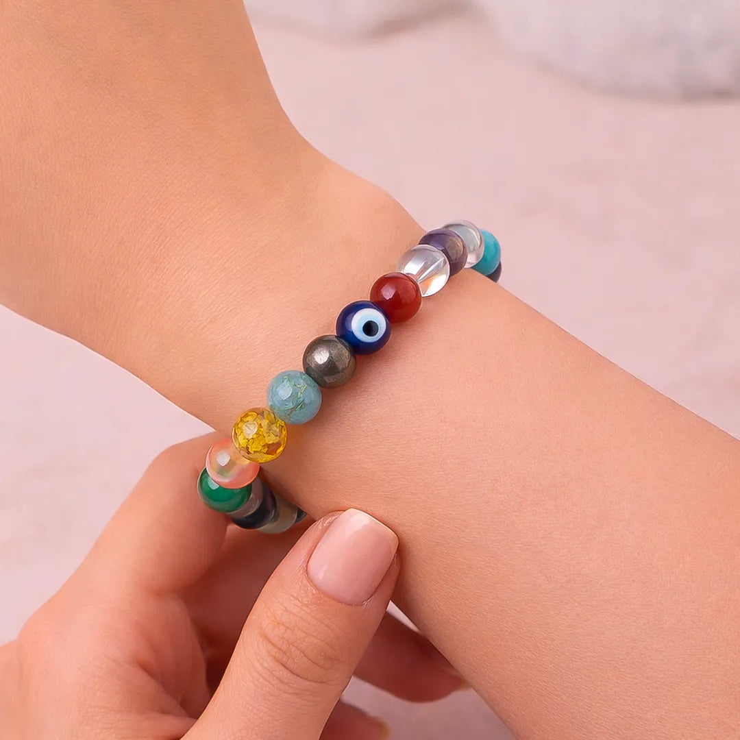 Colorful beaded bracelet on a wrist with a plain backgroundNaukari Success Bracelet – Career Growth & Job Stability Energy Band