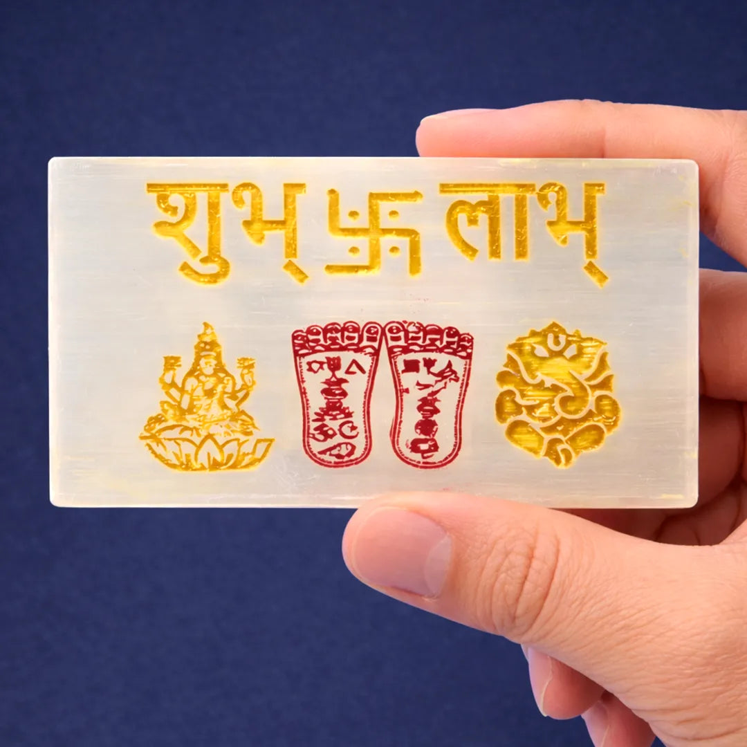 Hand holding a card with gold and red symbols and text against a blue background