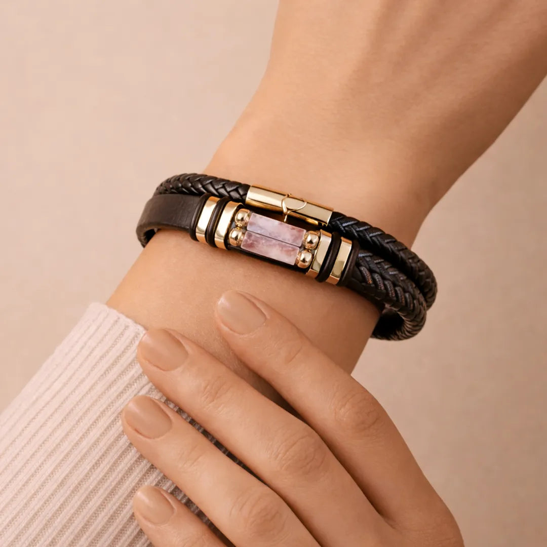 Bracelet with braided design and gold accents on a wrist against a beige backgroundRose Quartz Leather Bracelet (Relationship & Love)