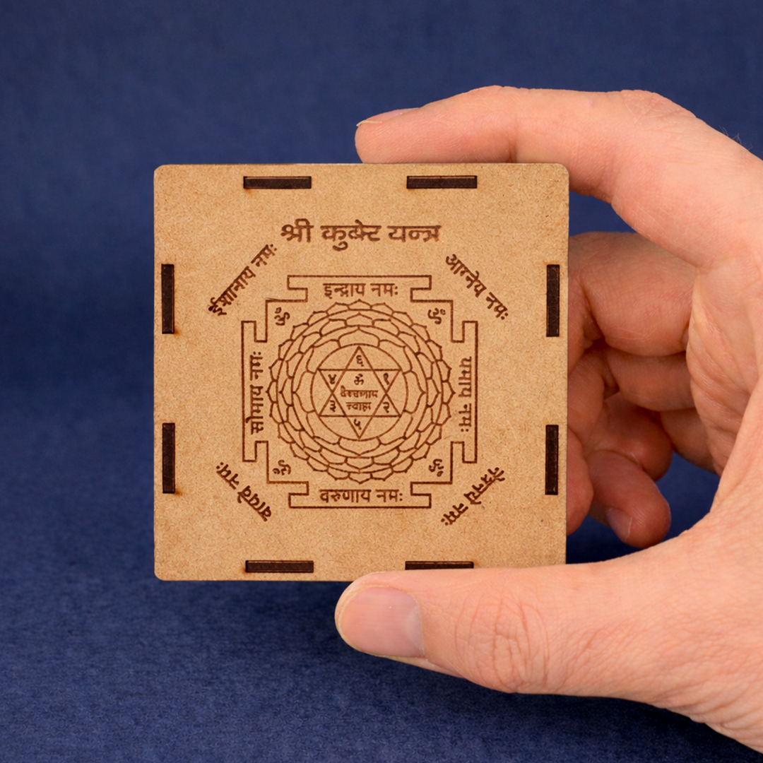 Hand holding a wooden box with intricate carvings against a blue background