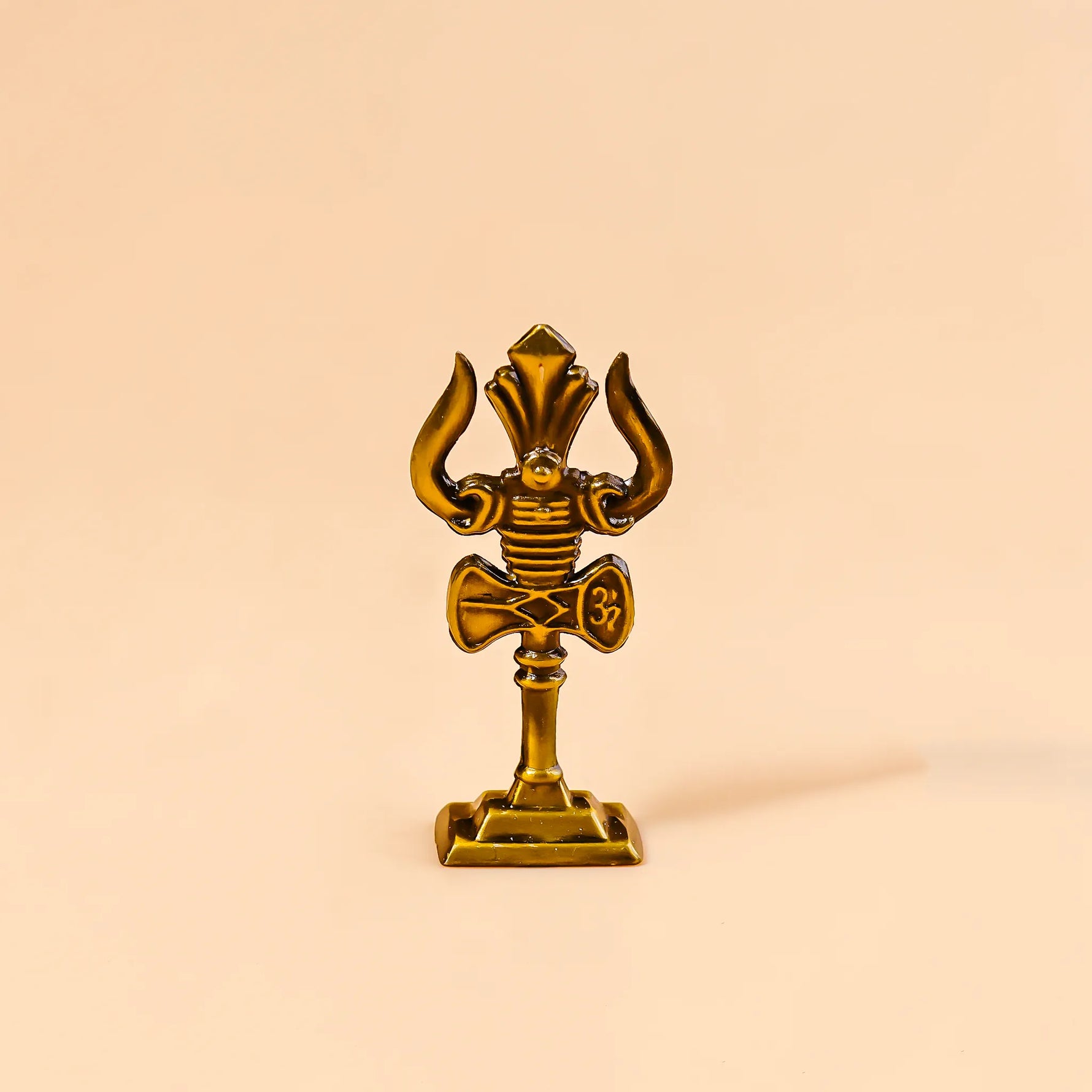 Gold decorative item with a unique design on a beige backgroundMurugan Trishul Vel – Abhimantrit & Certified