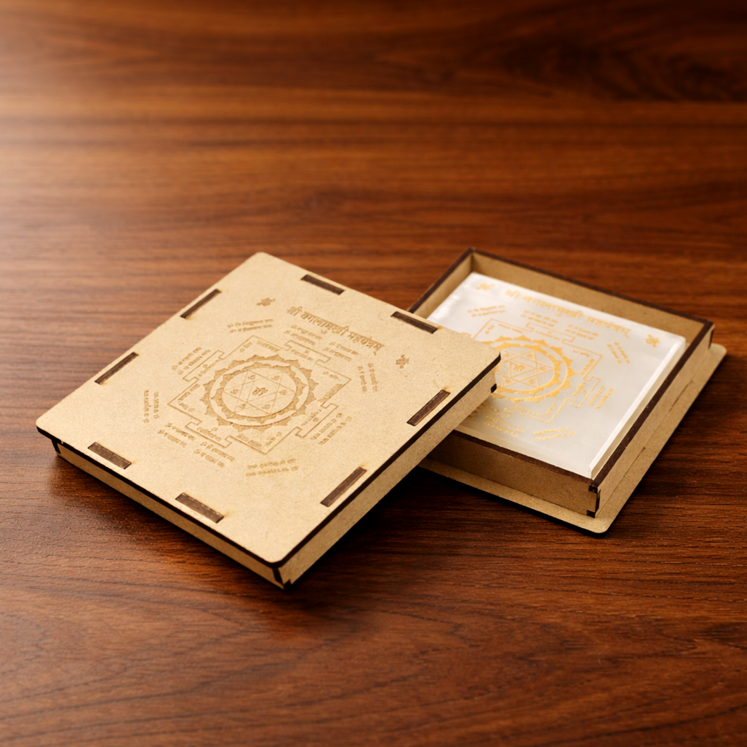 Wooden book-shaped box with intricate designs on a wooden surface