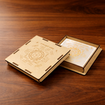 Wooden book-shaped box with intricate designs on a wooden surface