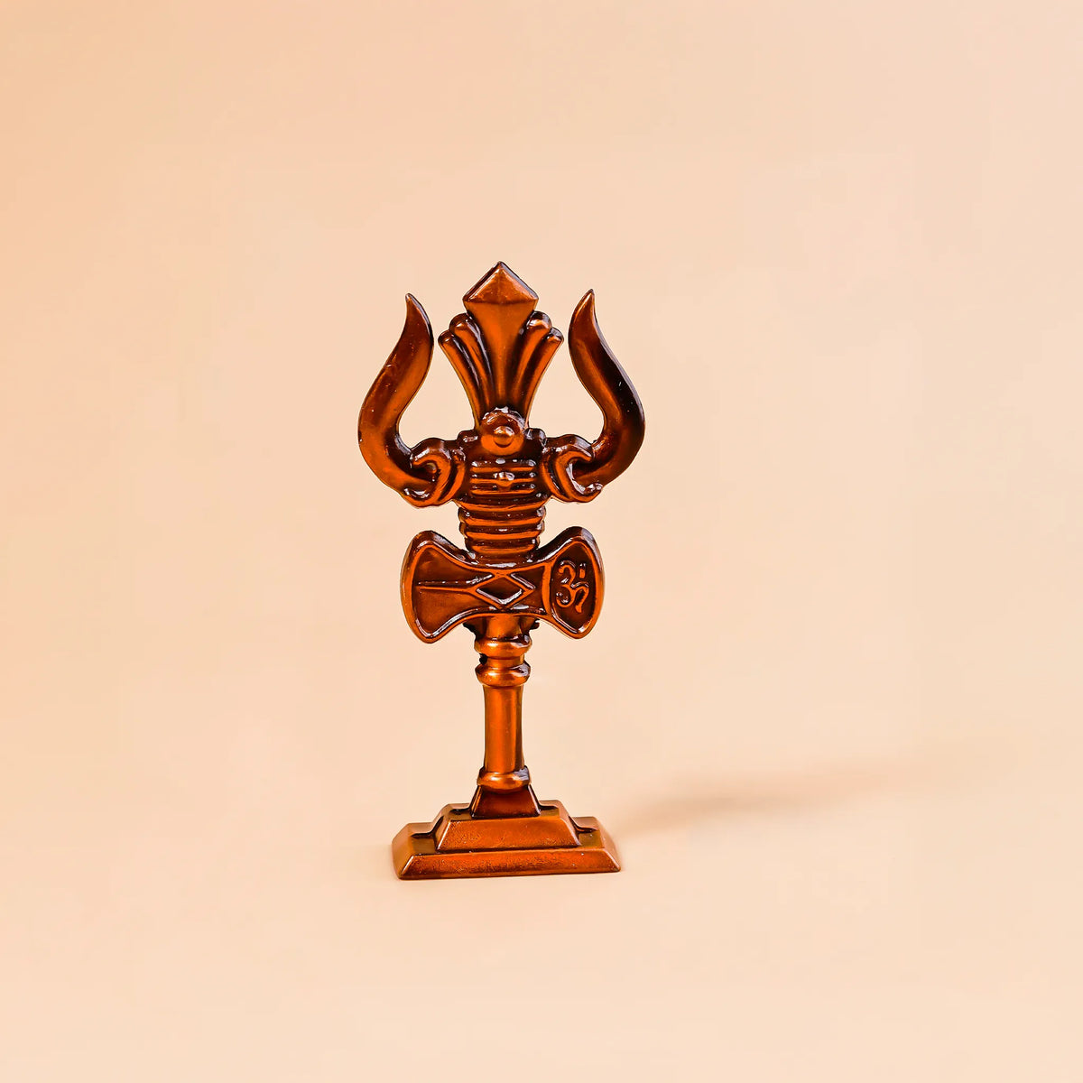 Decorative object resembling a trident on a beige background