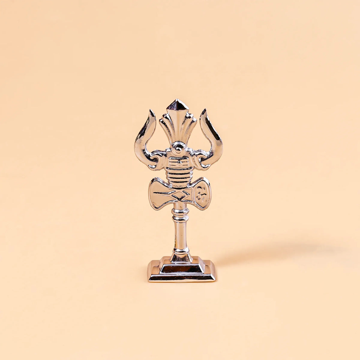 Decorative object resembling a trident on a beige background
