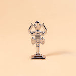 Decorative object resembling a trident on a beige background