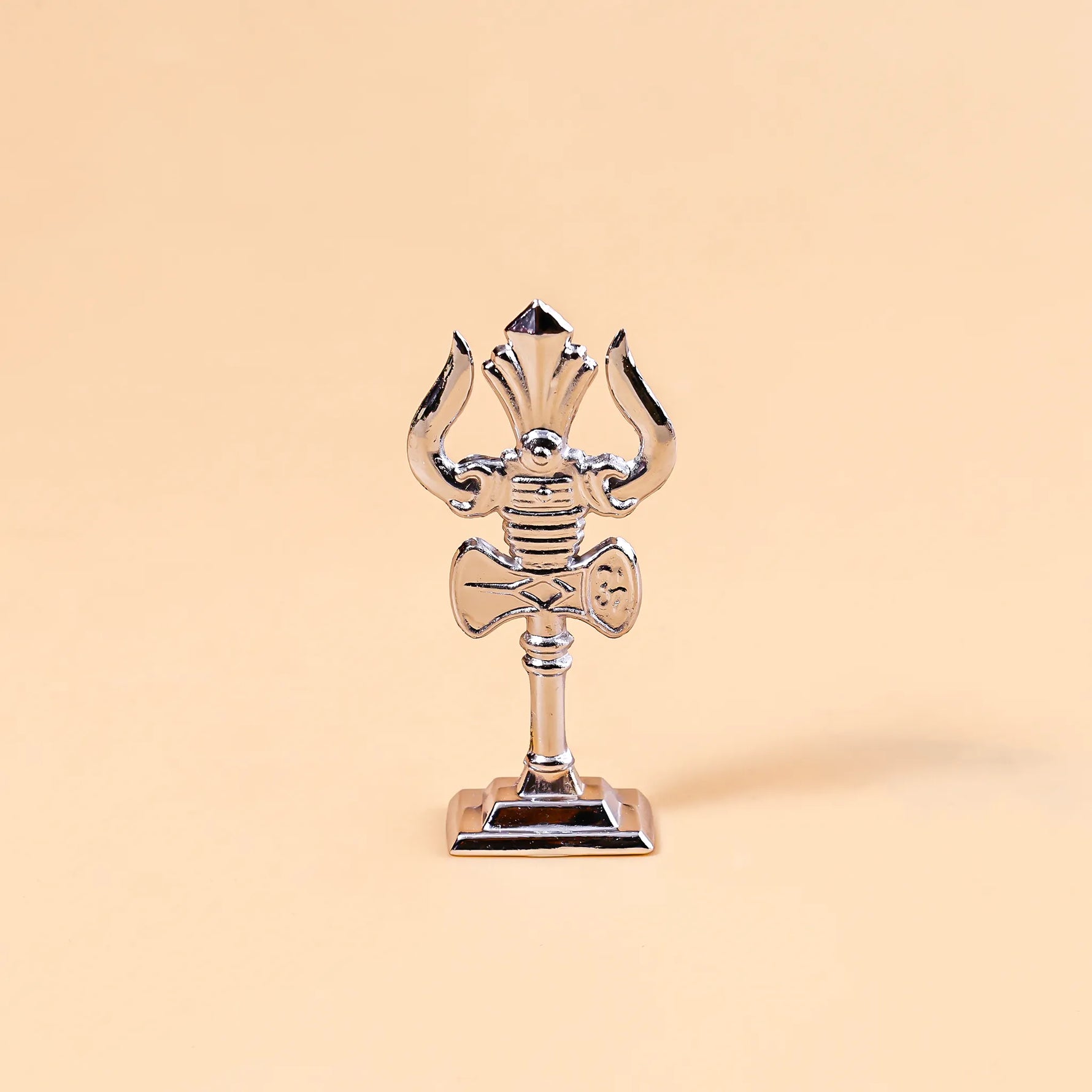 Decorative object resembling a trident on a beige backgroundMurugan Trishul Vel – Abhimantrit & Certified