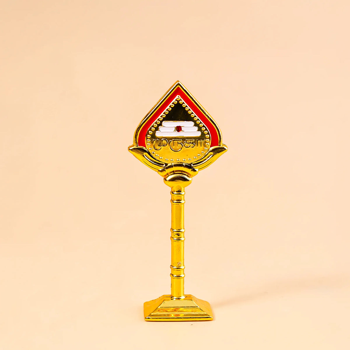 Decorative object with a red and gold design on a beige background