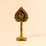 Decorative object with a central emblem on a beige background