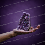 Purple crystal held in a hand against a purple background with 'Astro Dhwani' branding.