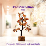 Decorative red carnelian tree with a blurred indoor setting in the background