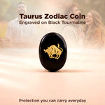 Taurus zodiac coin engraved on black tourmaline with a couple in the background