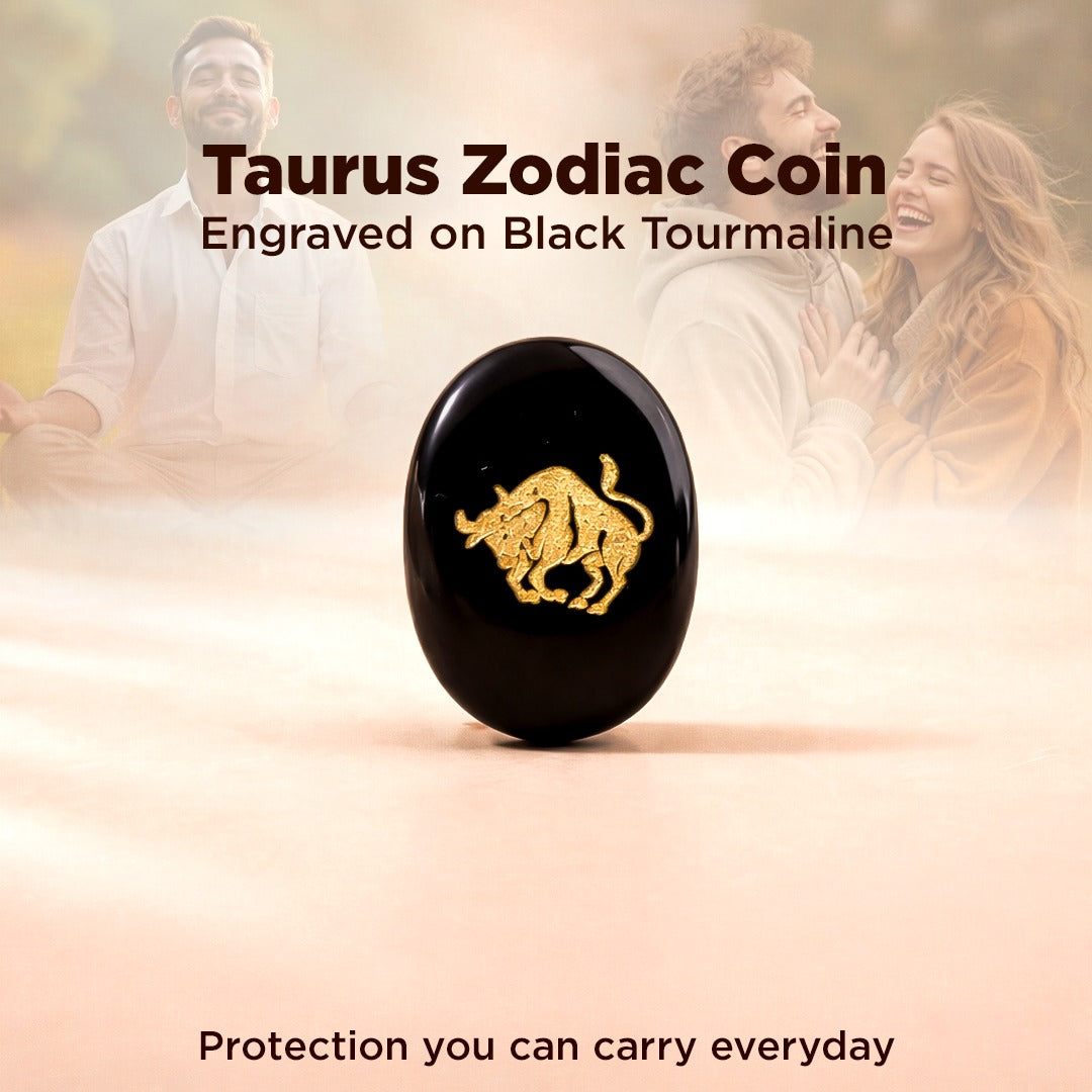 Taurus zodiac coin engraved on black tourmaline with a couple in the background