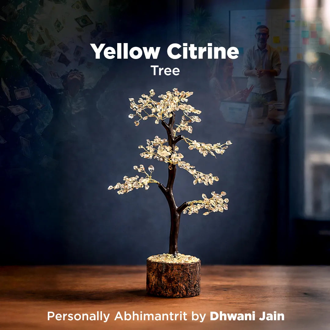 Decorative yellow citrine tree on a wooden surface with a blurred background