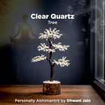 Clear Quartz Tree on a wooden base with a dark background and text overlay.