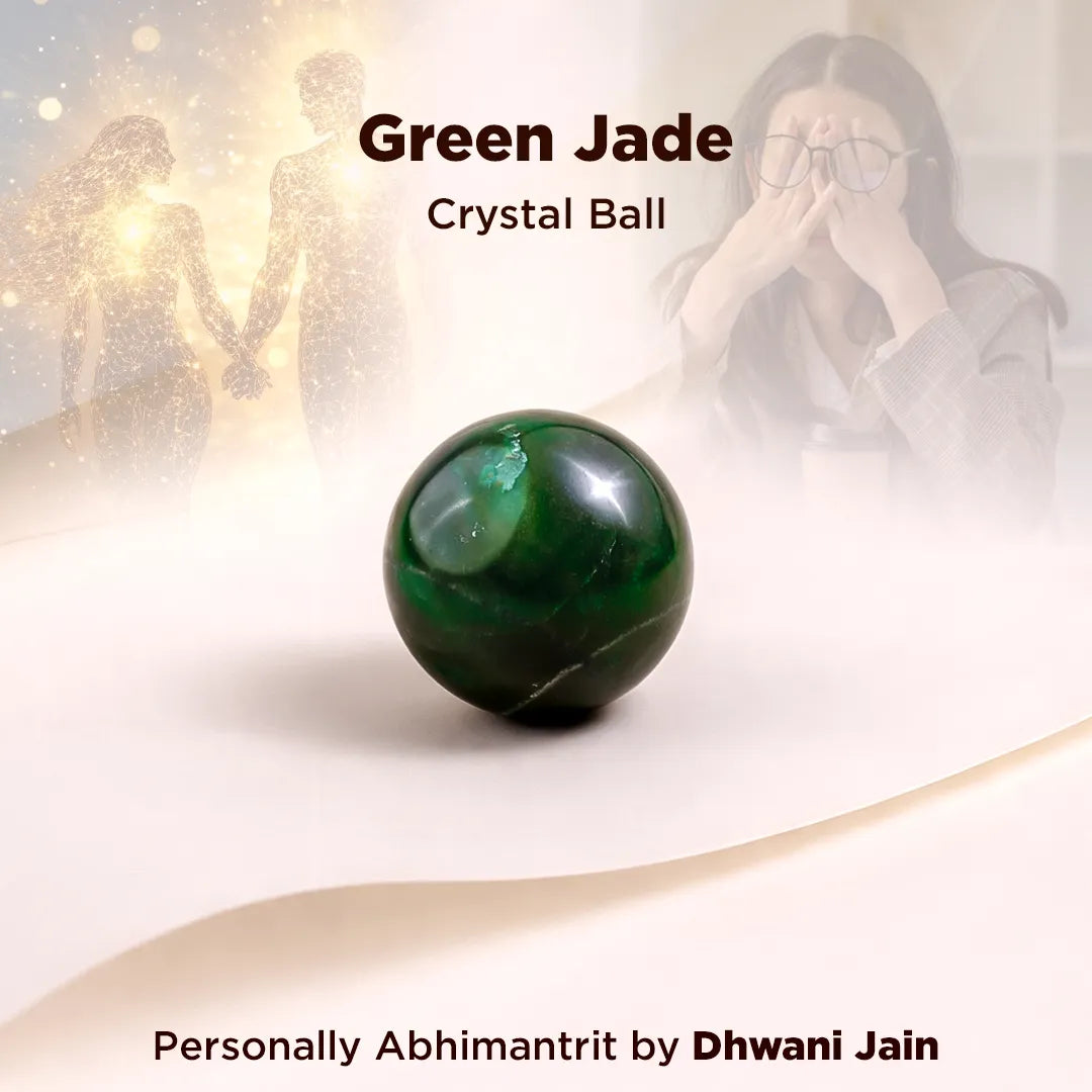 Green jade crystal ball on a white surface with a blurred background