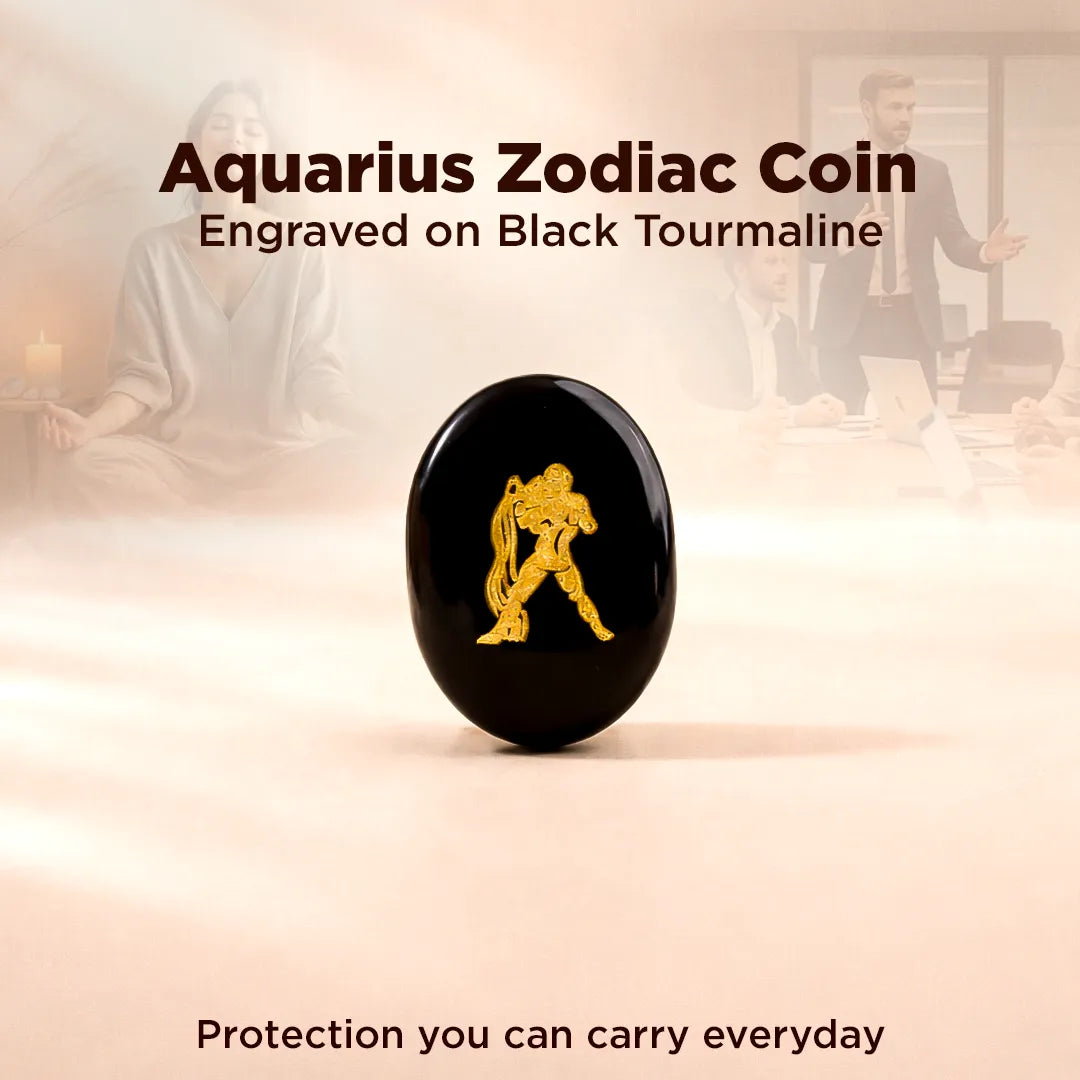 Black tourmaline coin with Aquarius zodiac symbol on a blurred background of people.