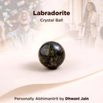 Labradorite crystal ball with blurred people in the background