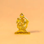 Gold decorative item on a peach background