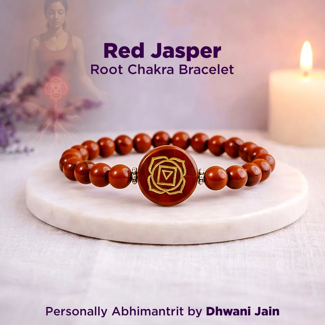 Red Jasper Root Chakra Bracelet on a white surface with a blurred background