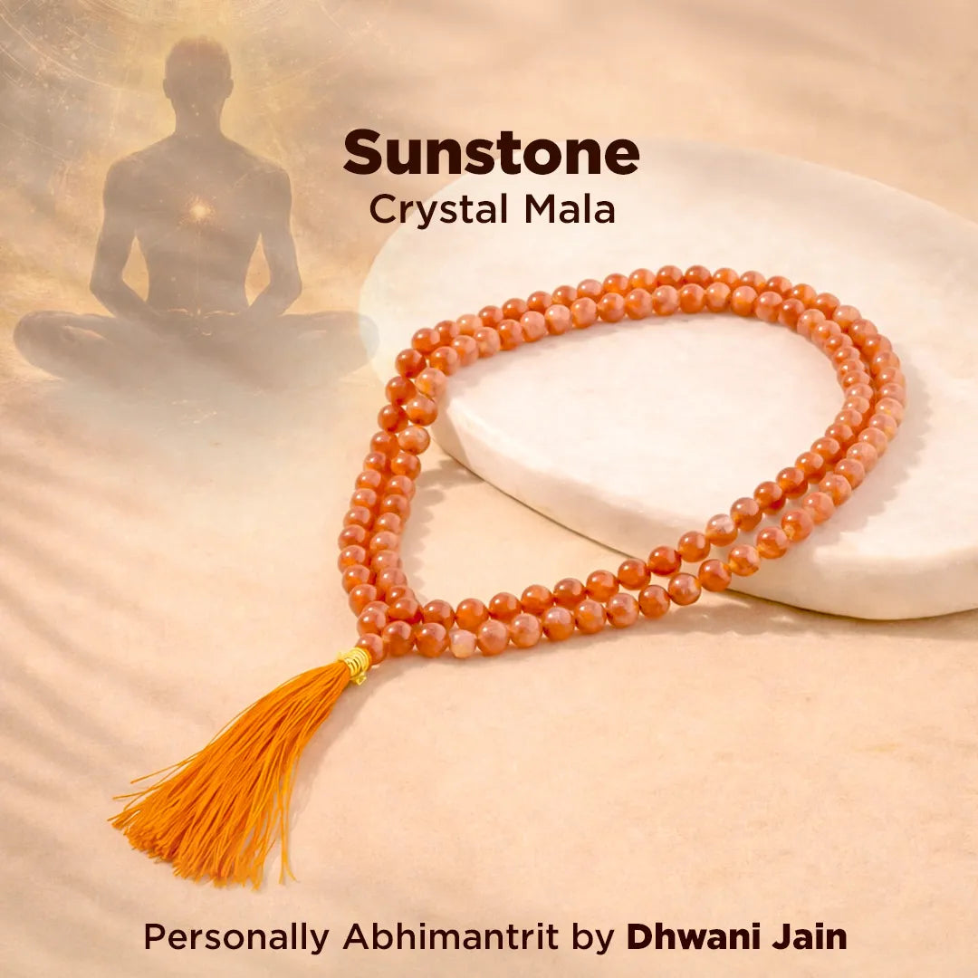 Sunstone Crystal Mala with a silhouette of a meditating person on a soft background