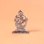 Decorative metal emblem with a peacock design on an orange background